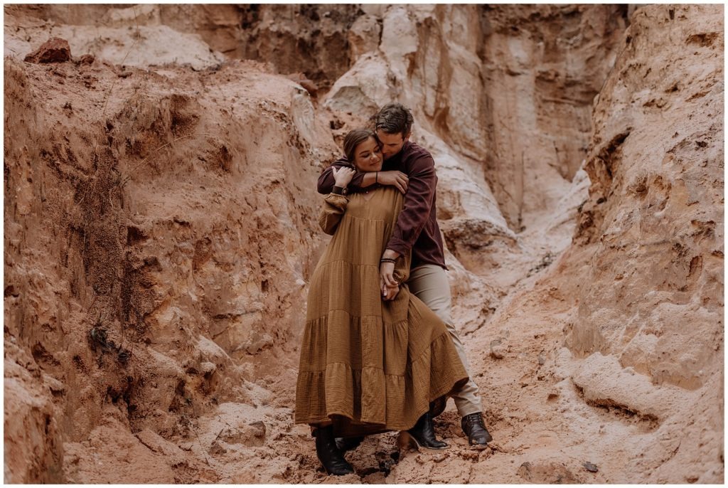 Man and woman snuggling at Providence Canyon